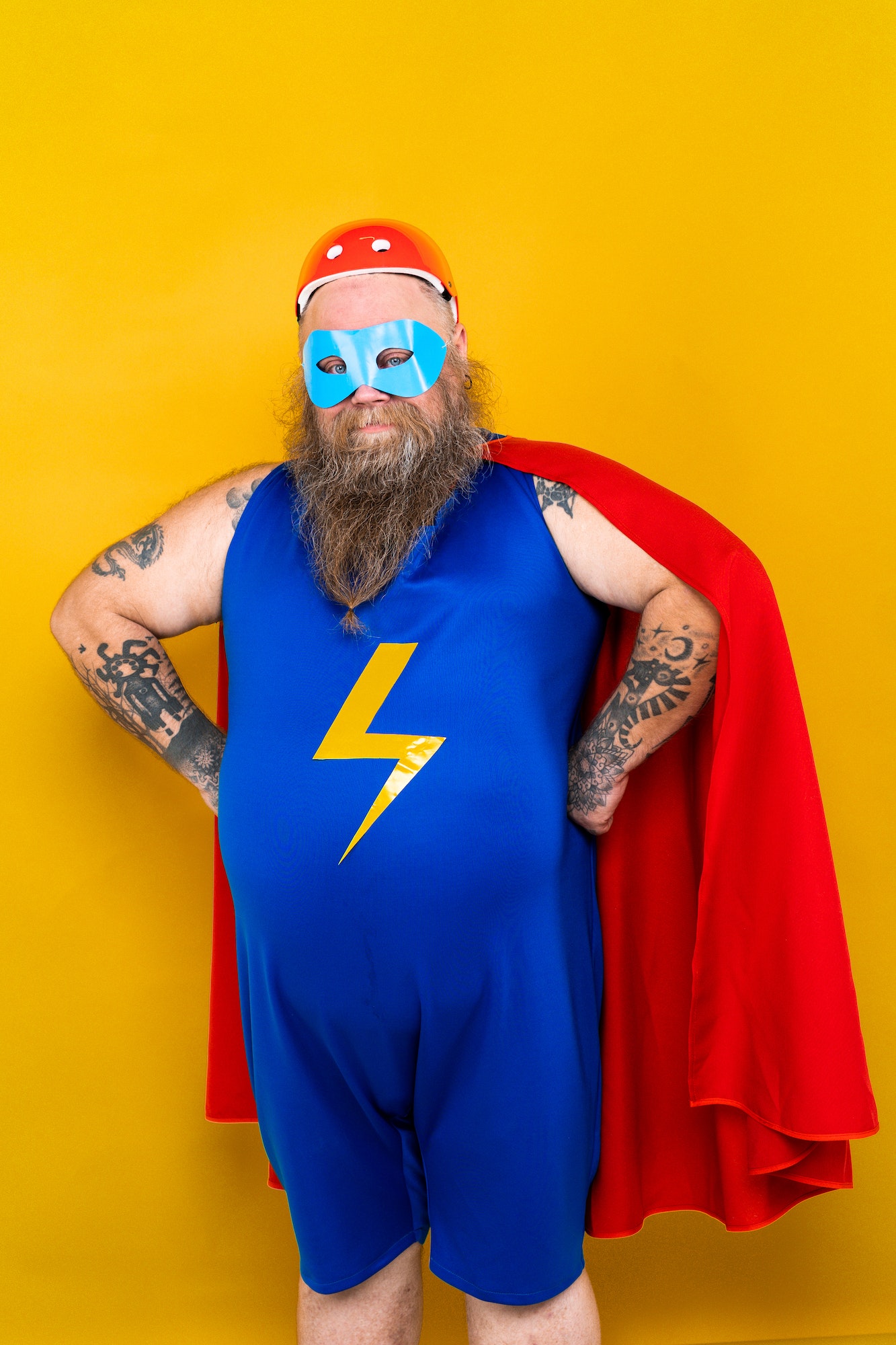 Funny fat man with superhero costume